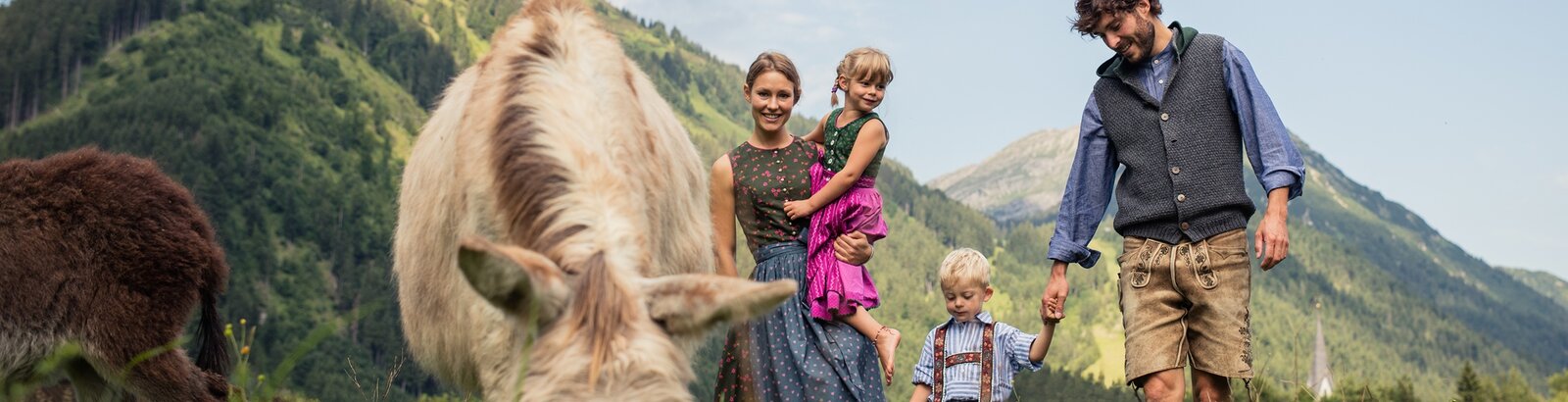 Family in traditional costume on the alp 