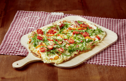 Flammkuchen with tomatoes and rocket salad
